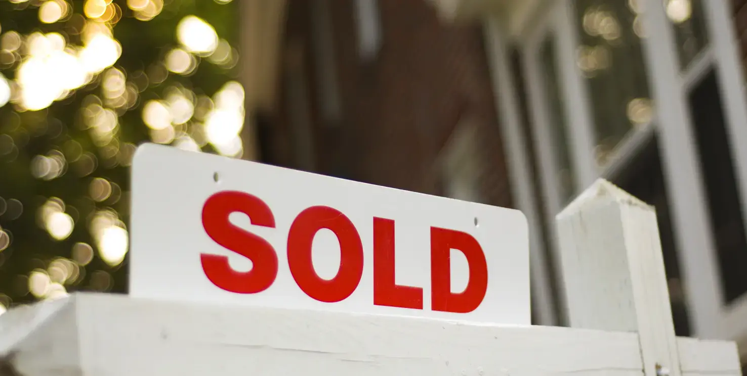 Sold sign in front of a house, representing an as-is home sale