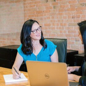 Home seller meeting with a prospective real estate agent at a brokerage office.
