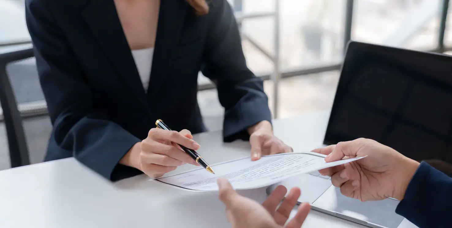 Realtor reviewing a real estate listing agreement with a client