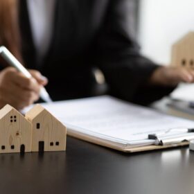 Real estate agent discussing contract contingencies with client at desk