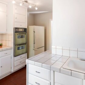 Outdated kitchen in need of repairs and updates, illustrating challenges of selling a house that needs work.